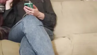 The MILF looks at the phone while giving him a hand job