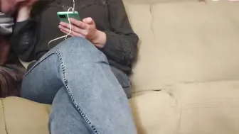 The MILF looks at the phone while giving him a hand job
