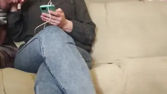 The MILF looks at the phone while giving him a hand job