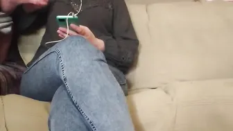 The MILF looks at the phone while giving him a hand job