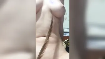 The red-haired women plays with her body. Caressing the breast with a feather. Boobies tight suckers st