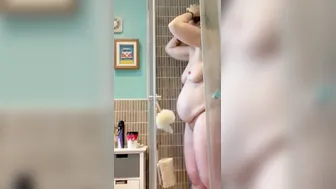 Pregnant red haired mom gets undressed and taking a shower