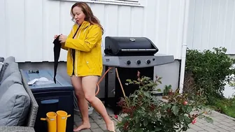 Gets clothed into rubber dress stay ups raincoat and pvc boots