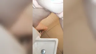Pee into a urinal into a guyss outdoor restroom