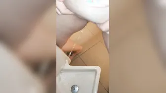 Pee into a urinal into a guyss outdoor restroom