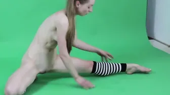 Young dark haired gymnast Anna Mostik spreading legs