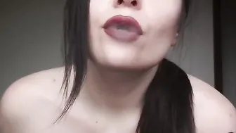 Vaping with ddark red lips close see
