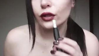 Vaping with ddark red lips close see