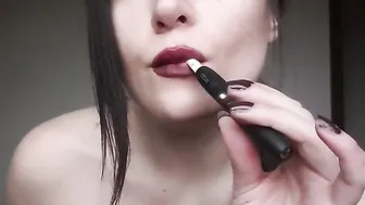Vaping with ddark red lips close see