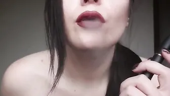Vaping with ddark red lips close see