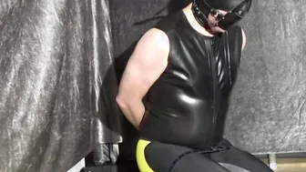 Female Domination bound up man with yoga panel gag and leather hood