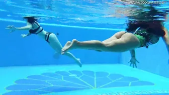 Beauty babes with long titties swim underwater inside the pool
