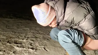 Piss into the snow outdoors
