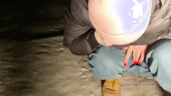 Piss into the snow outdoors