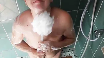 Nudist housekeeper Regina Noir washes inside the shower with soap