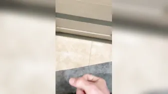 the dude jerks inside the restroom and ejaculates at the door