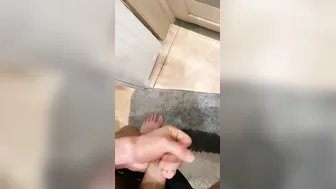 the dude jerks inside the restroom and ejaculates at the door