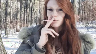 red haired smokes inside the forest