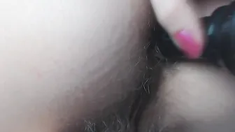 Drilling bushy asshole with ebony vibrator close up