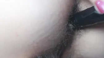 Drilling bushy asshole with ebony vibrator close up