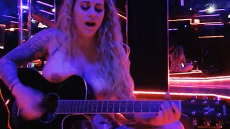 Having Fun guitar and singing a cover topless into club