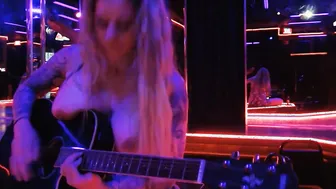 Having Fun guitar and singing a cover topless into club