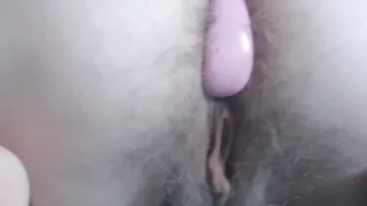 Pink Anal beads inside bushy asshole close up under white lingerie