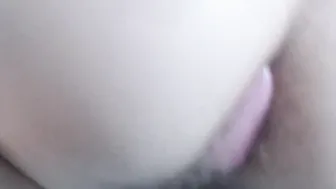 Pink Anal beads inside bushy asshole close up under white lingerie