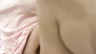 Young unshaved woman squirts on bed