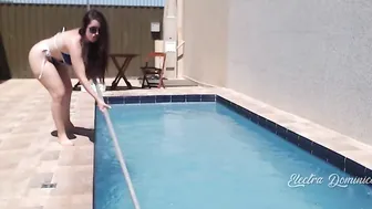 Very Goddess dark hair cleaning the pool