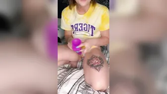 Miss Coxxx grips a toy while wearing a light up ass plug
