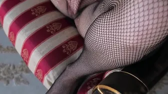 a blonde inside a ebony bodysuit and tights masturbates her