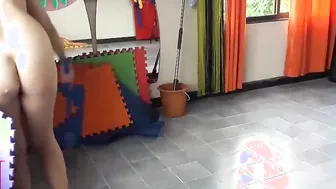 Nudist maid cleans the yoga room. A nude cleaner cleans