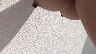 Breasts jesena leaning against wall