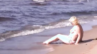 goddess cougar inside a white bikini on the beach