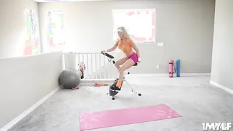 Incredible Sexy MILF workouts while ride a pink dilido on her stationary bike
