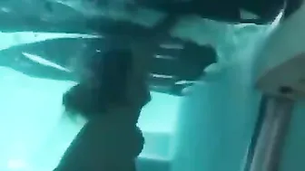Topless girl drowning underwater