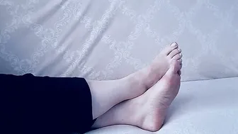 For comfort Anna sits barefoot on the sofa - two