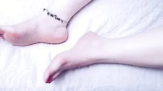 Anna is wearing an ankle accessory. She shows off her
