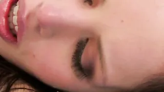 Slim dark haired with gigantic bee-stung lips fucks herself rough with dildo and toy on bed.