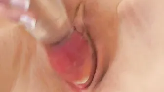 Slim dark haired with gigantic bee-stung lips fucks herself rough with dildo and toy on bed.