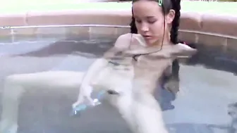 Tiny Tabby Masturbating her pussy using dildo at the pool