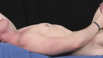 Muscular uncircumcised dude strokes his cock on massage table.