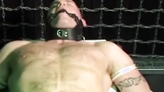 Submissive young man moans as he is gagged and tied up