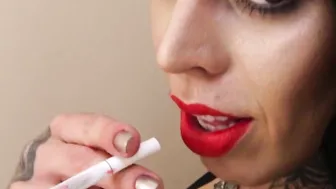 While Watching porn video – Stunning tattooed shemale takes a smoke and teases solo