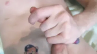 Cute twink with tattoos strokes his big dick and cums