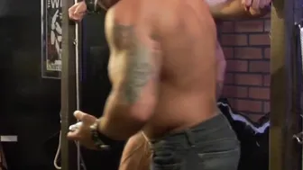Hunk in bondage gear enjoying domination by his buff partner