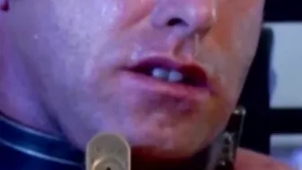 Submissive man struggles while in chains and dominated