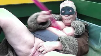 Naughty mature naturist playing outside