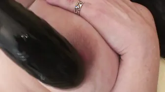 Big titted mama playing with a toy
